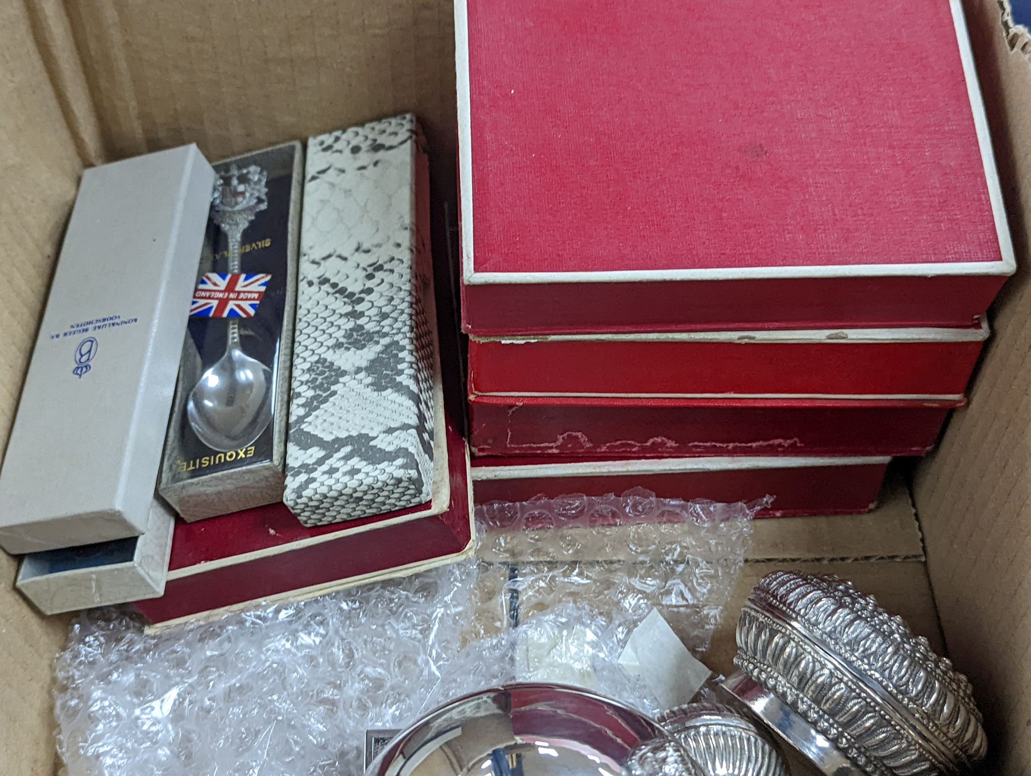 A collection of assorted white metal items including Thai boxes, Burmese figures of dancers, dishes, candlesticks, tea strainer etc. and a quantity of assorted boxed flatware.